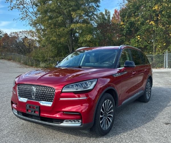 A red 2021 Lincoln Aviator parked in a dealer lot