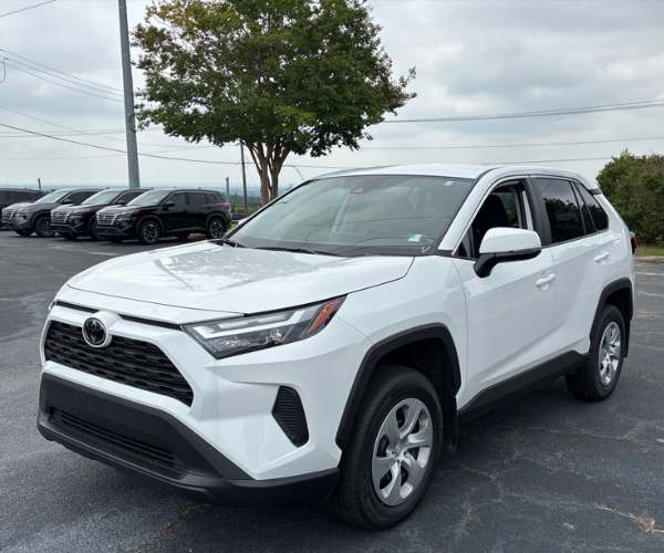 A grey Toyota RAV4 in an empty parking lot