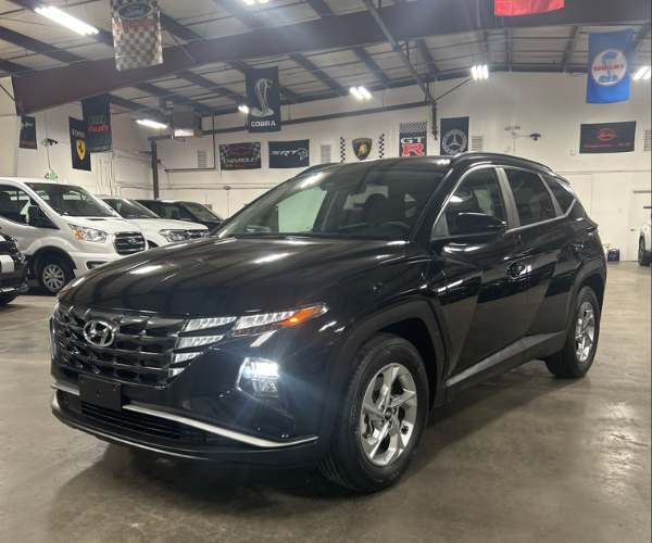 A black Toyota Highlander in an empty parking lot