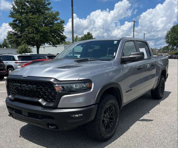 A Grey Chevrolet Silverado in a busy dealer parking lot