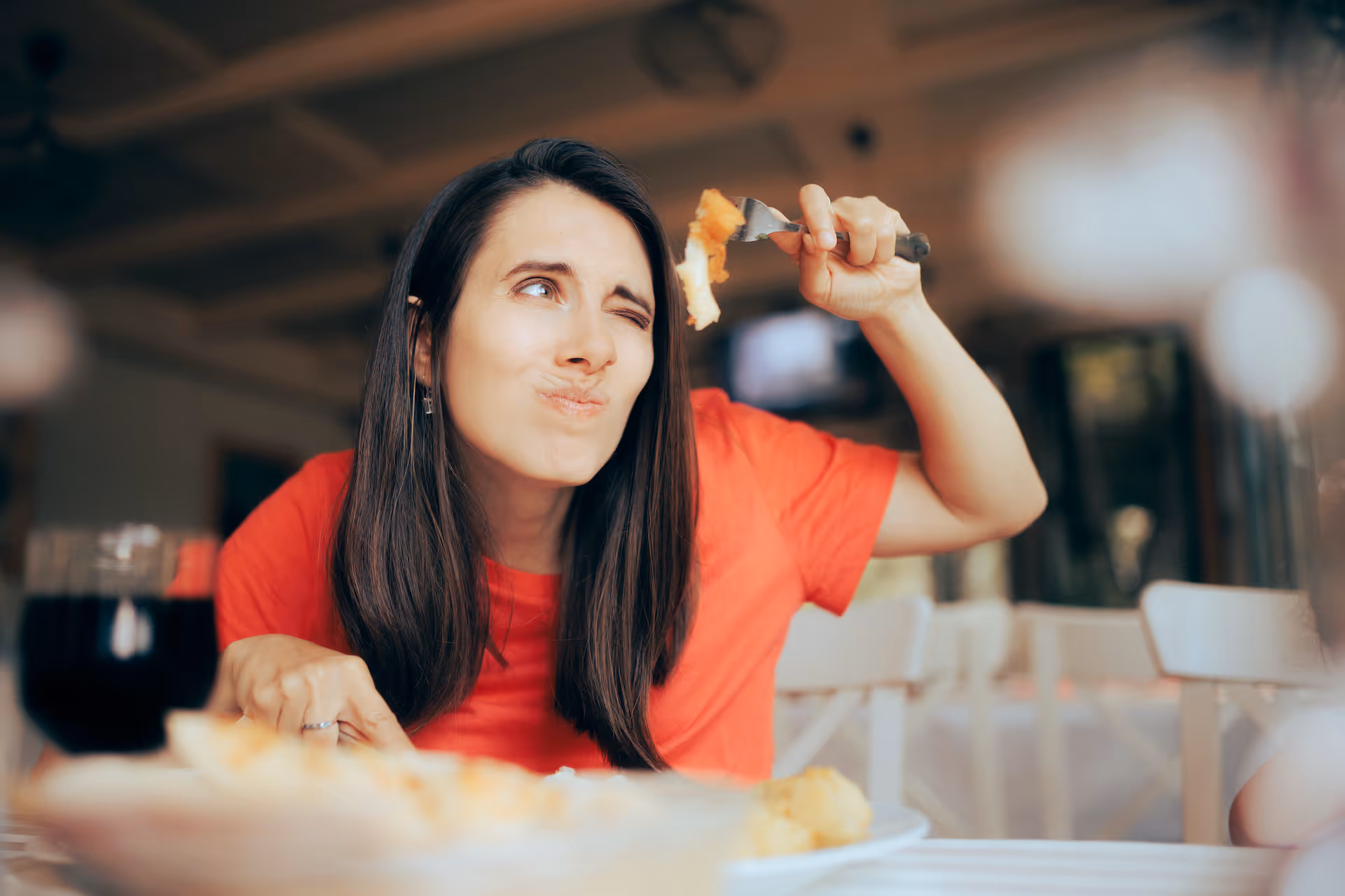 Woman Over Analyzing Food Course in a Restaurant