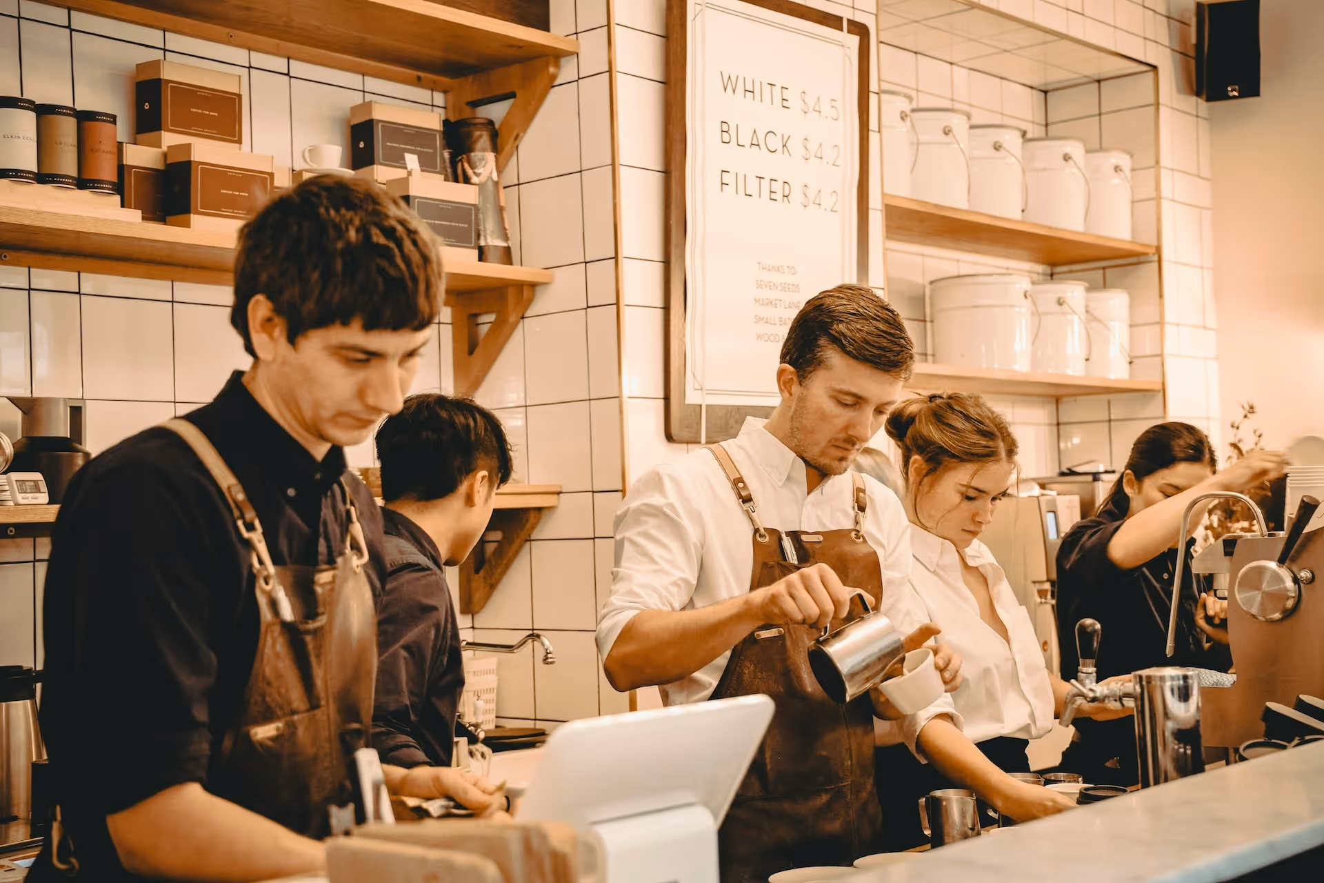 Baristas work at a busy coffee station