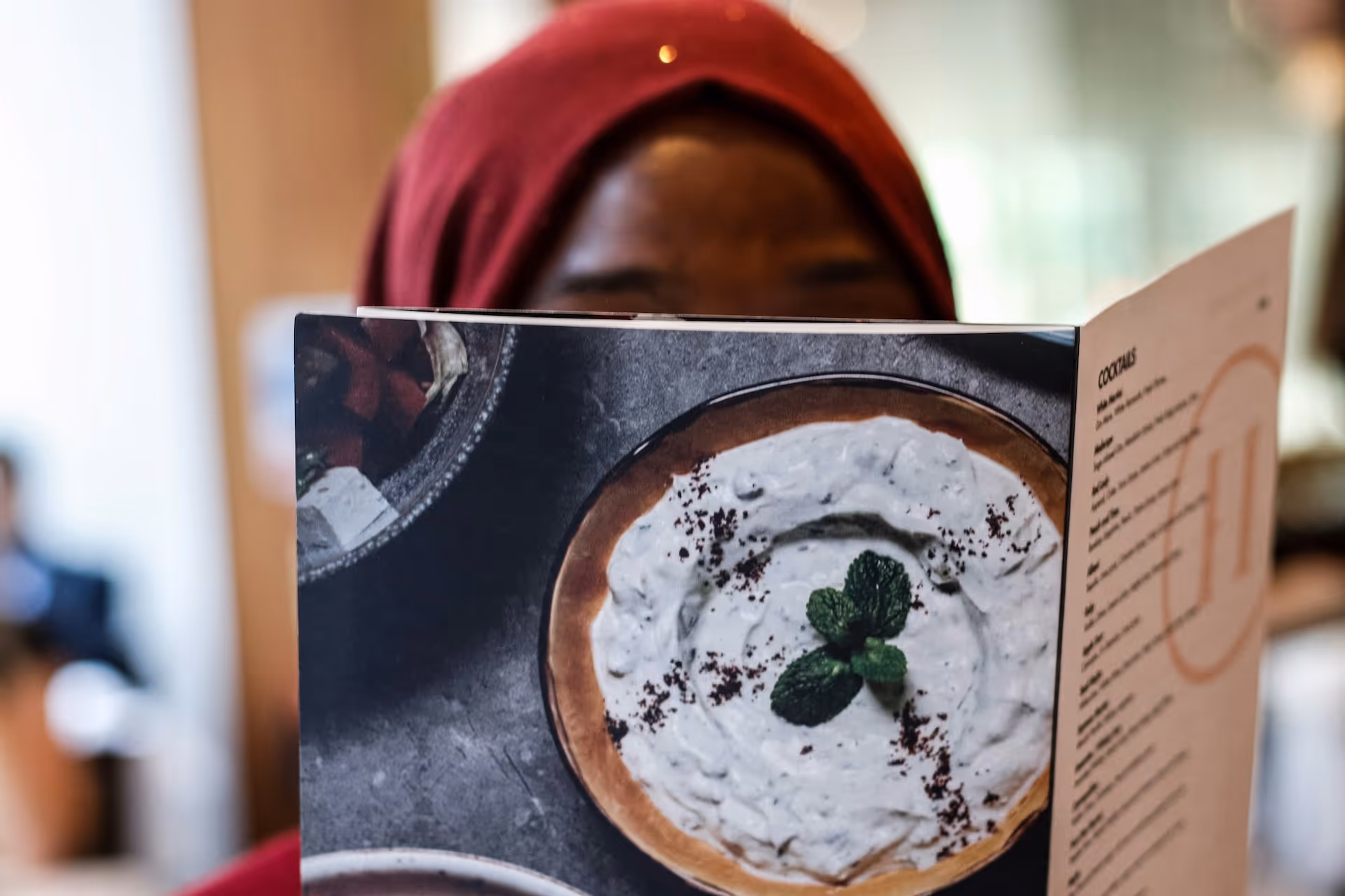 Woman reading menu at a restaurant