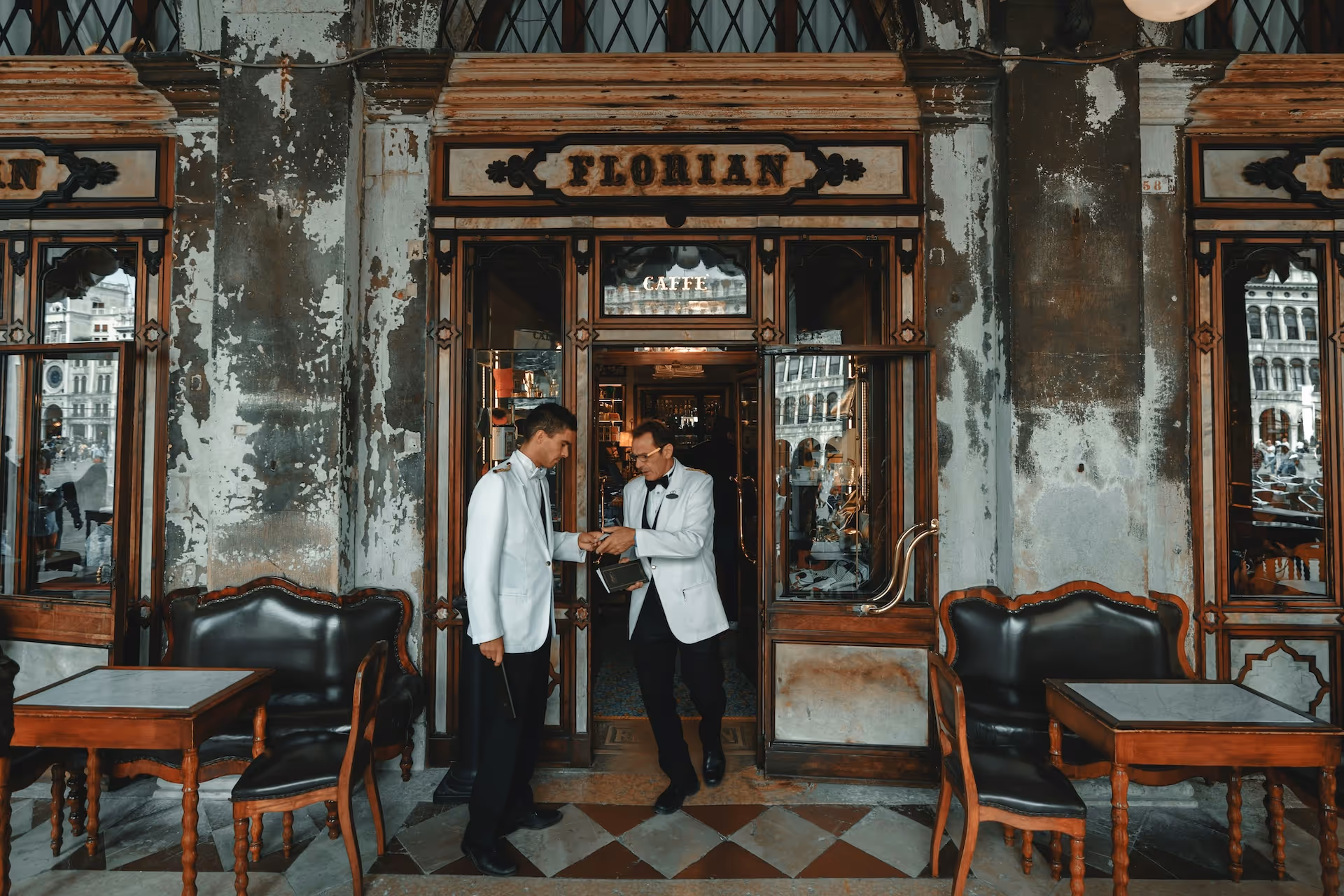 Two waiters outside a restaurant