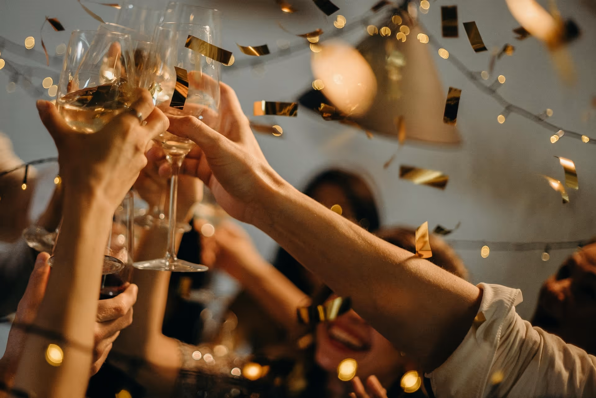 Raised glass and confetti