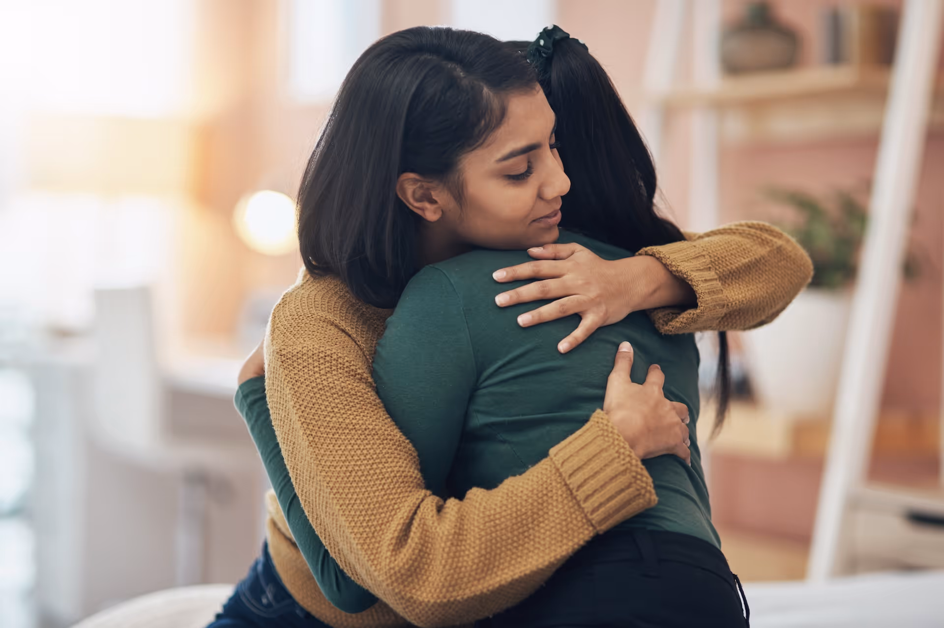 two young women embracing each other at a celebration of life event