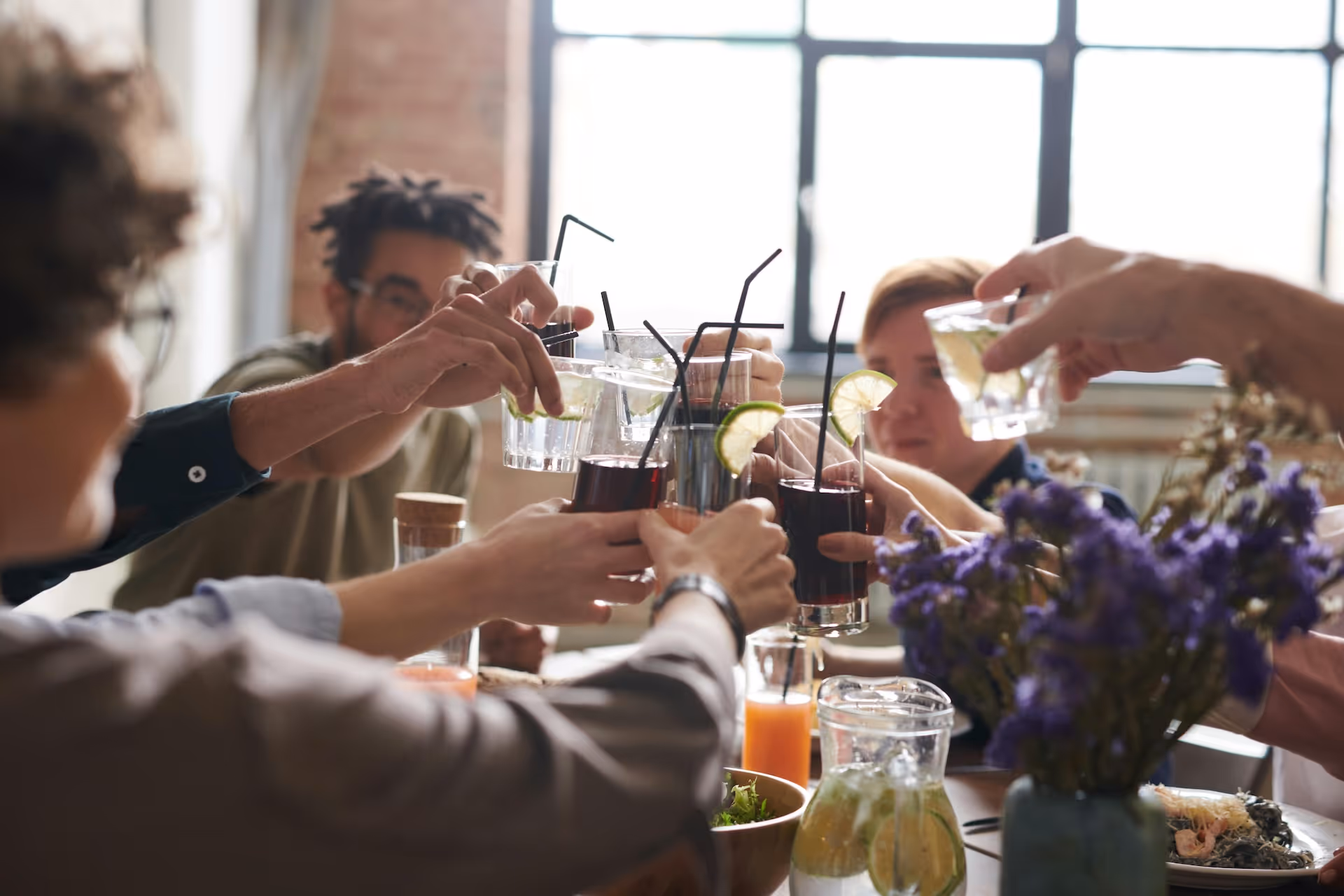 friends toasting with fruity drinks