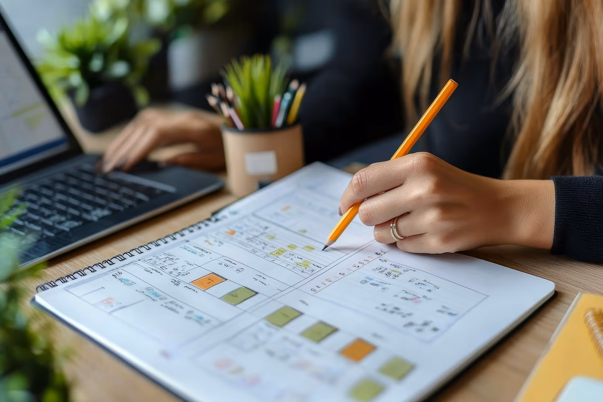 woman hand writing with pencil planning event on notebook