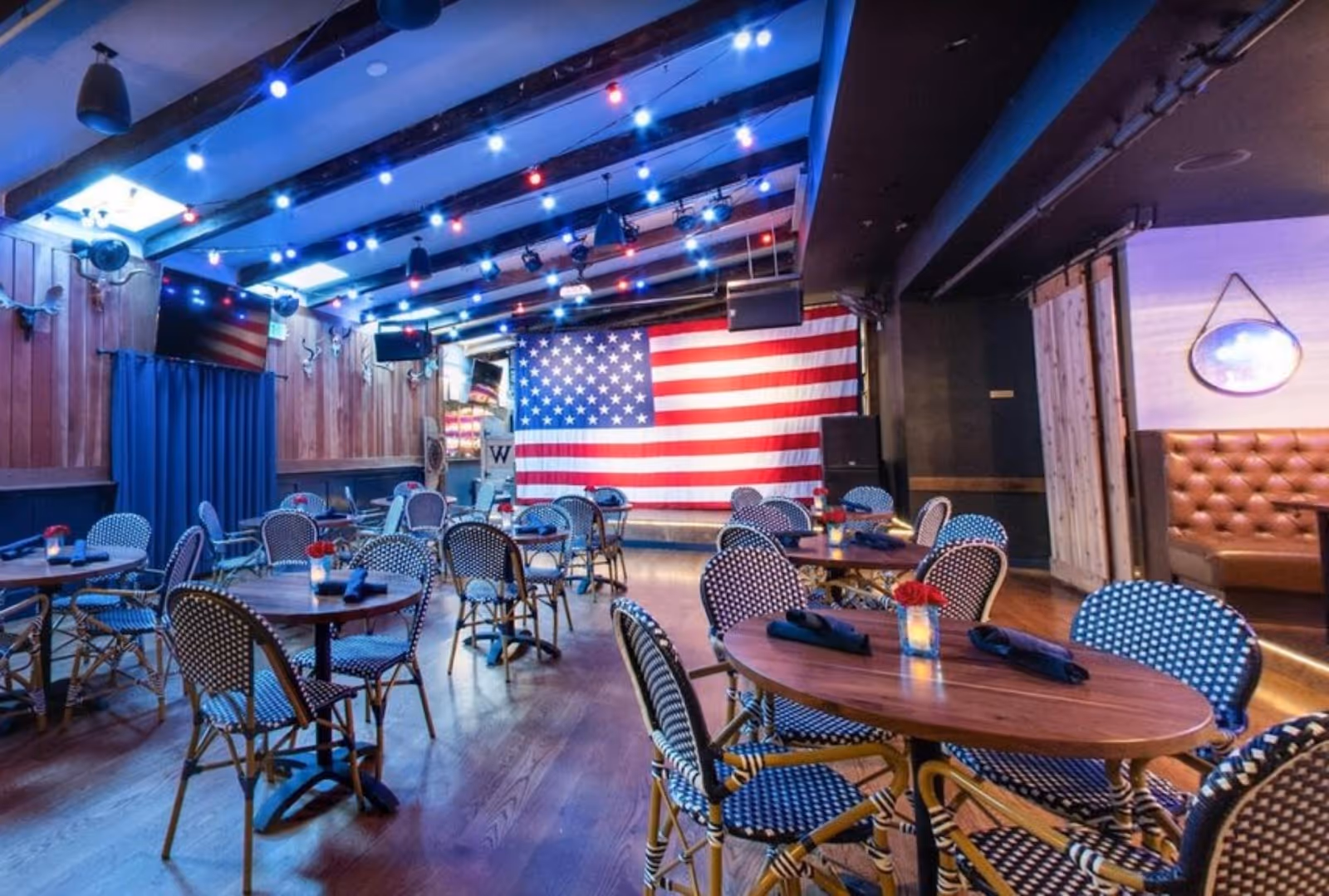 interior view of seating in Westwood restaurant, San Francisco, with the American Flag proudly hoisted on the stage
