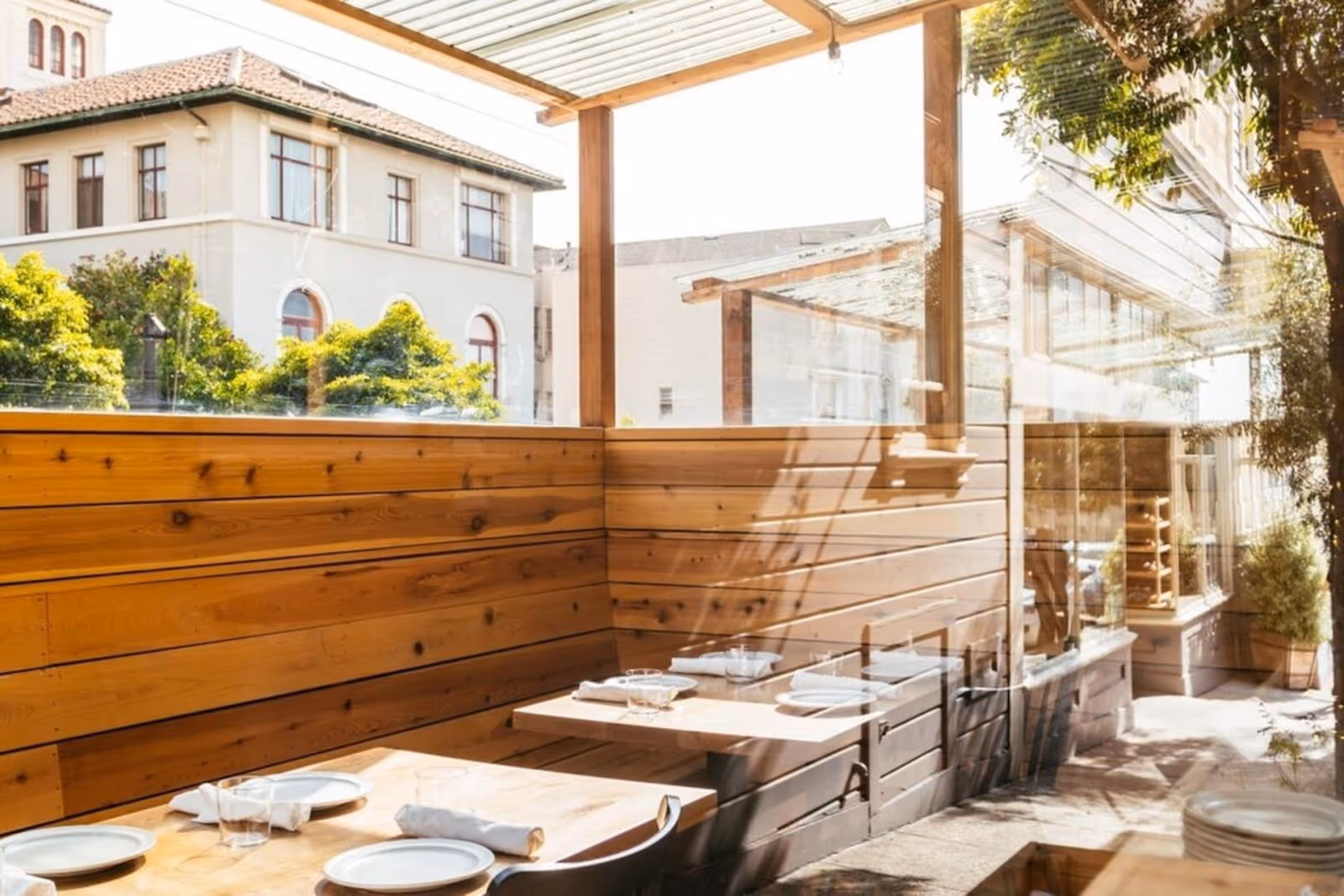 sunlight pouring into Octavia restaurant, SF, with large windows looking out at the street