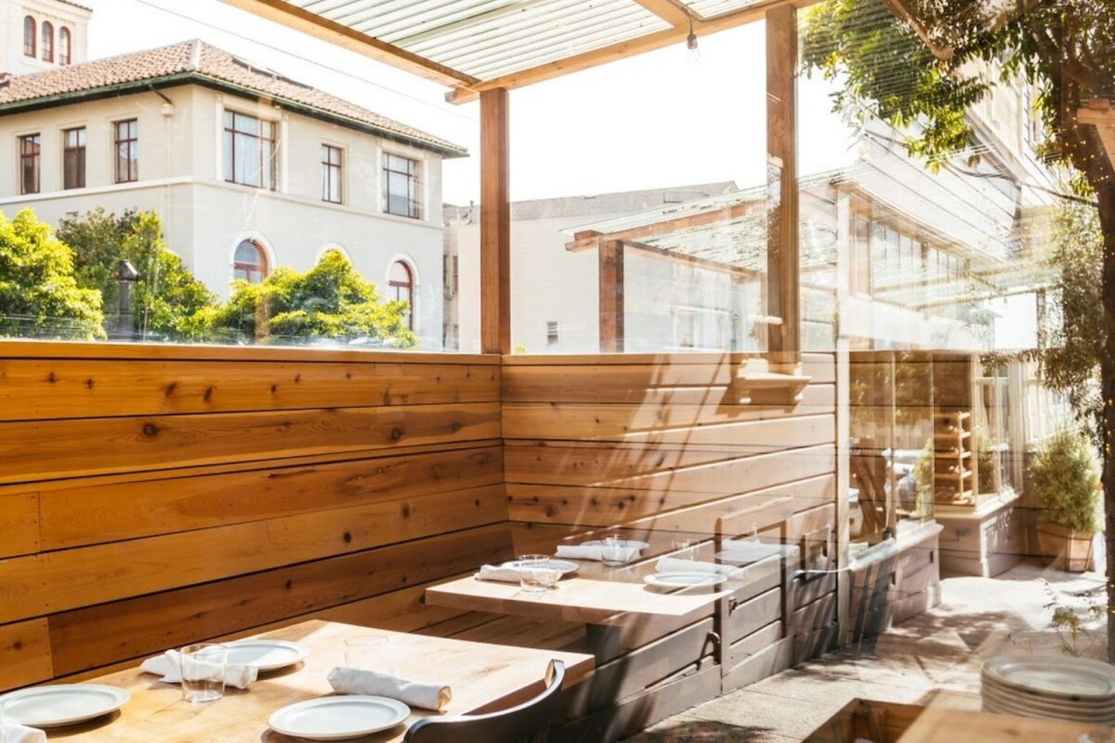 sunlight pouring into Octavia restaurant, SF, with large windows looking out at the street