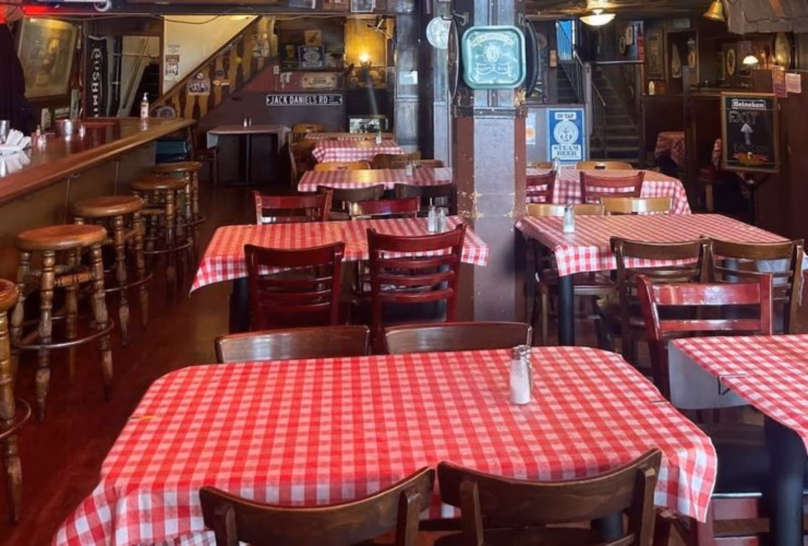 interior view of picnic-style dining tables and bar at Tommy's Joynt restaurant, SF