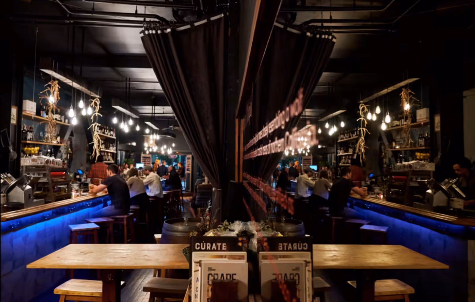 El Lopo restaurant packed with diners with a long dining table in the foreground