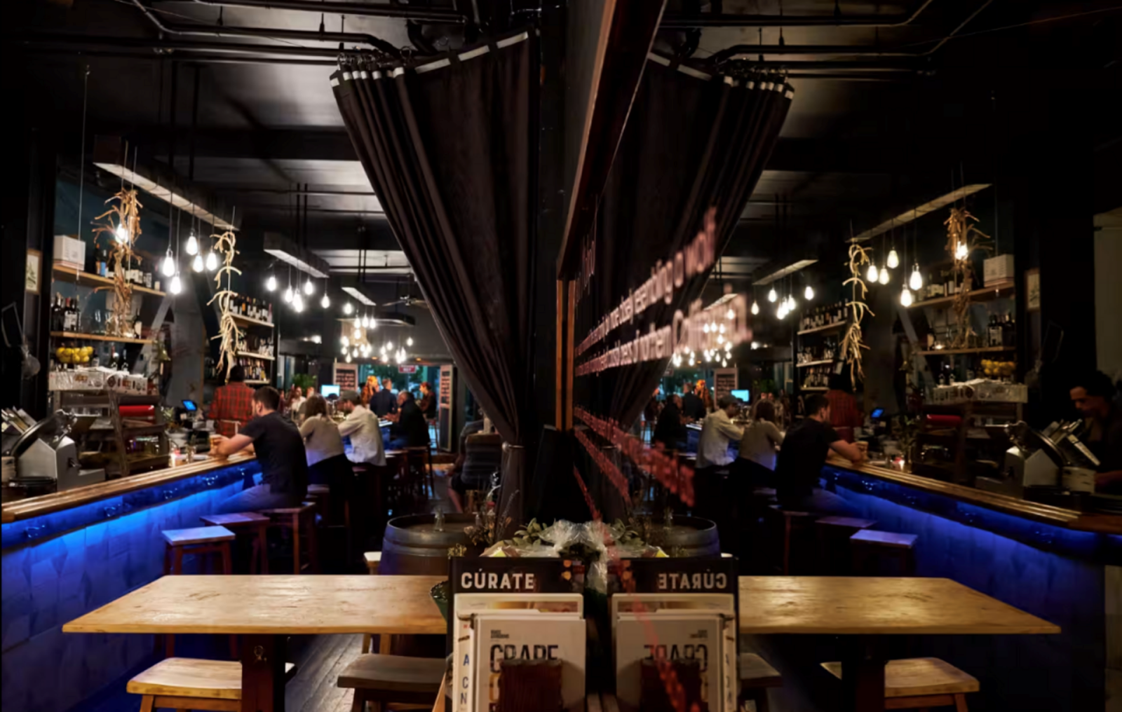 El Lopo restaurant packed with diners with a long dining table in the foreground