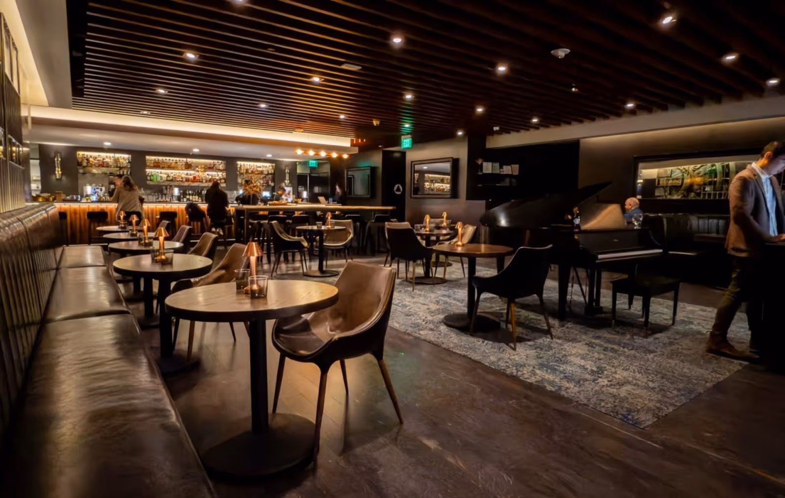 interior view of The Vault Steakhouse Piano Lounge, SF, with dining tables, bar, and pianist