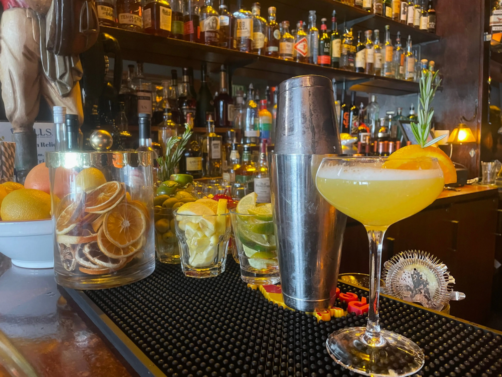 colorful cocktails on the counter of a fully-stocked bar
