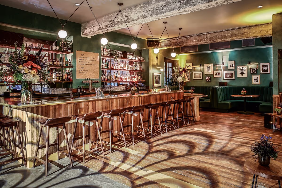 interior view of August Hall restaurant's dining booths and fully-stocked bar, Union Square SF