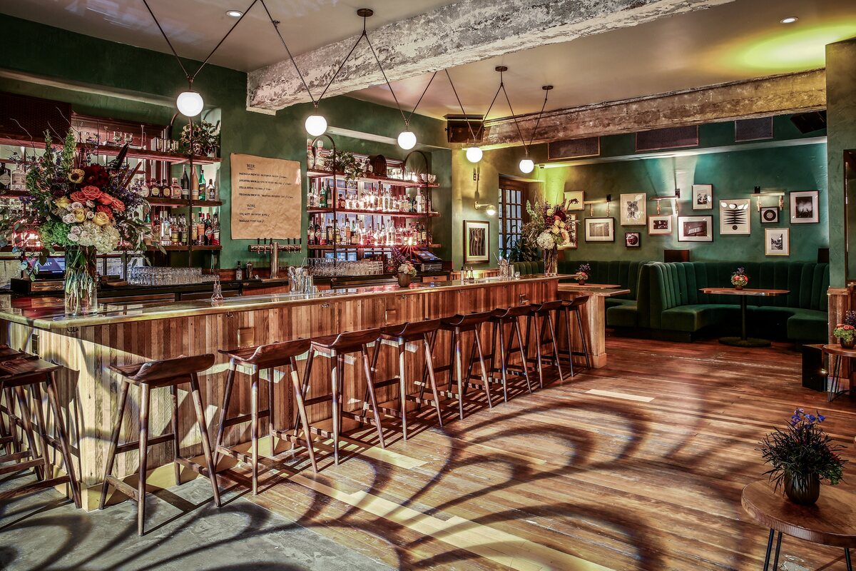interior view of August Hall restaurant's dining booths and fully-stocked bar, Union Square SF