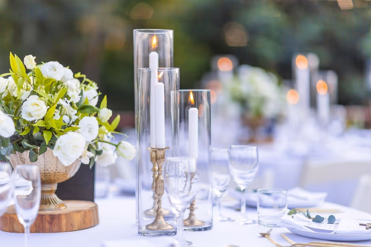 elegant candles and flowers on a table for an event