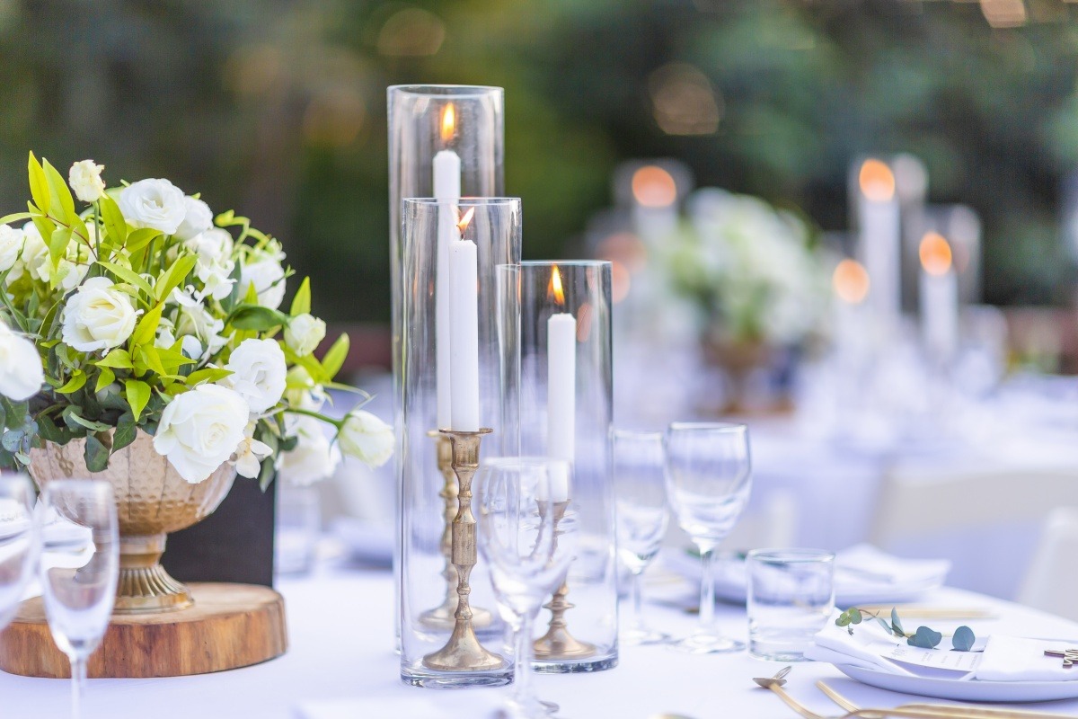 elegant candles and flowers on a table for an event