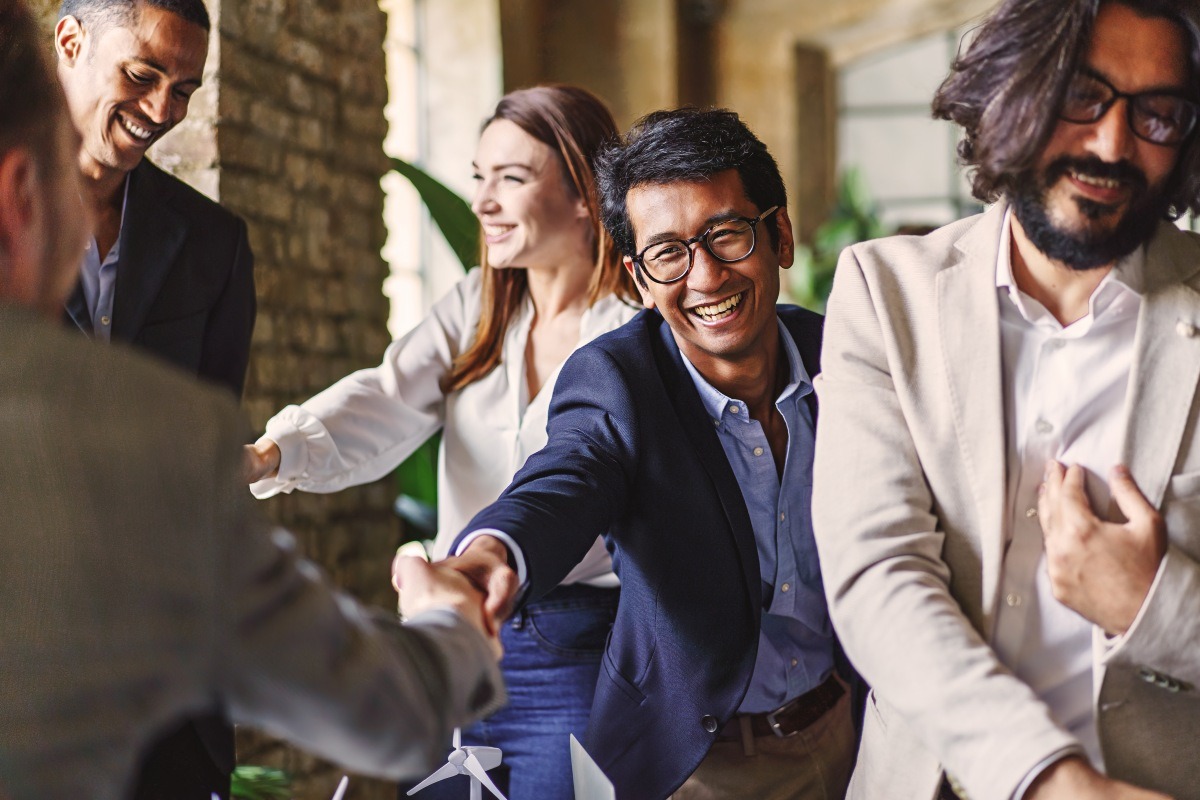 People smiling and shaking hands