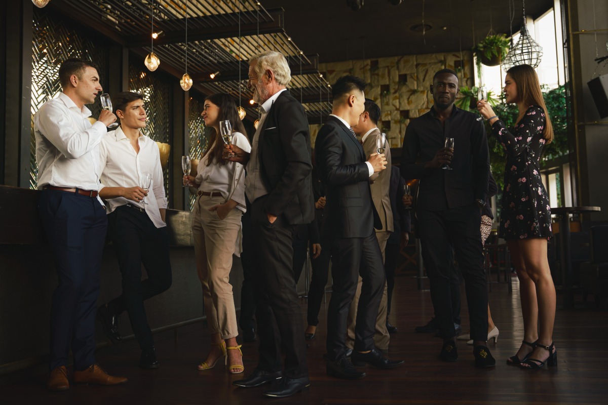 Business people standing and networking at corporate event