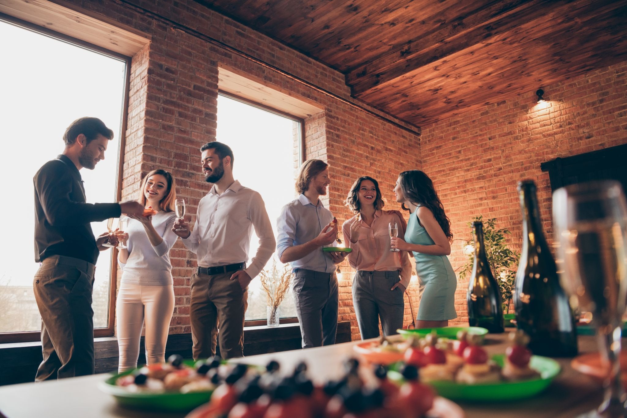 Event with people chatting and eating platters