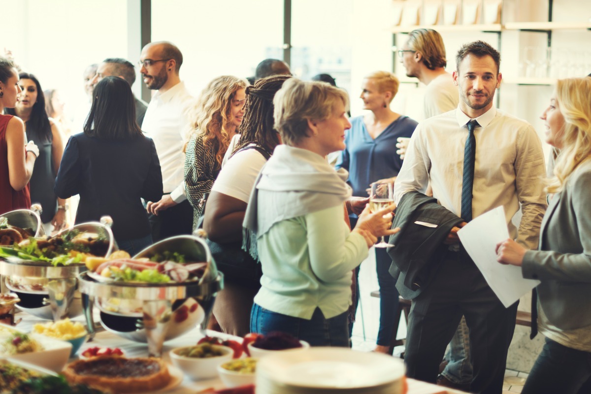 Event with food and drinks where people are chatting and socializing