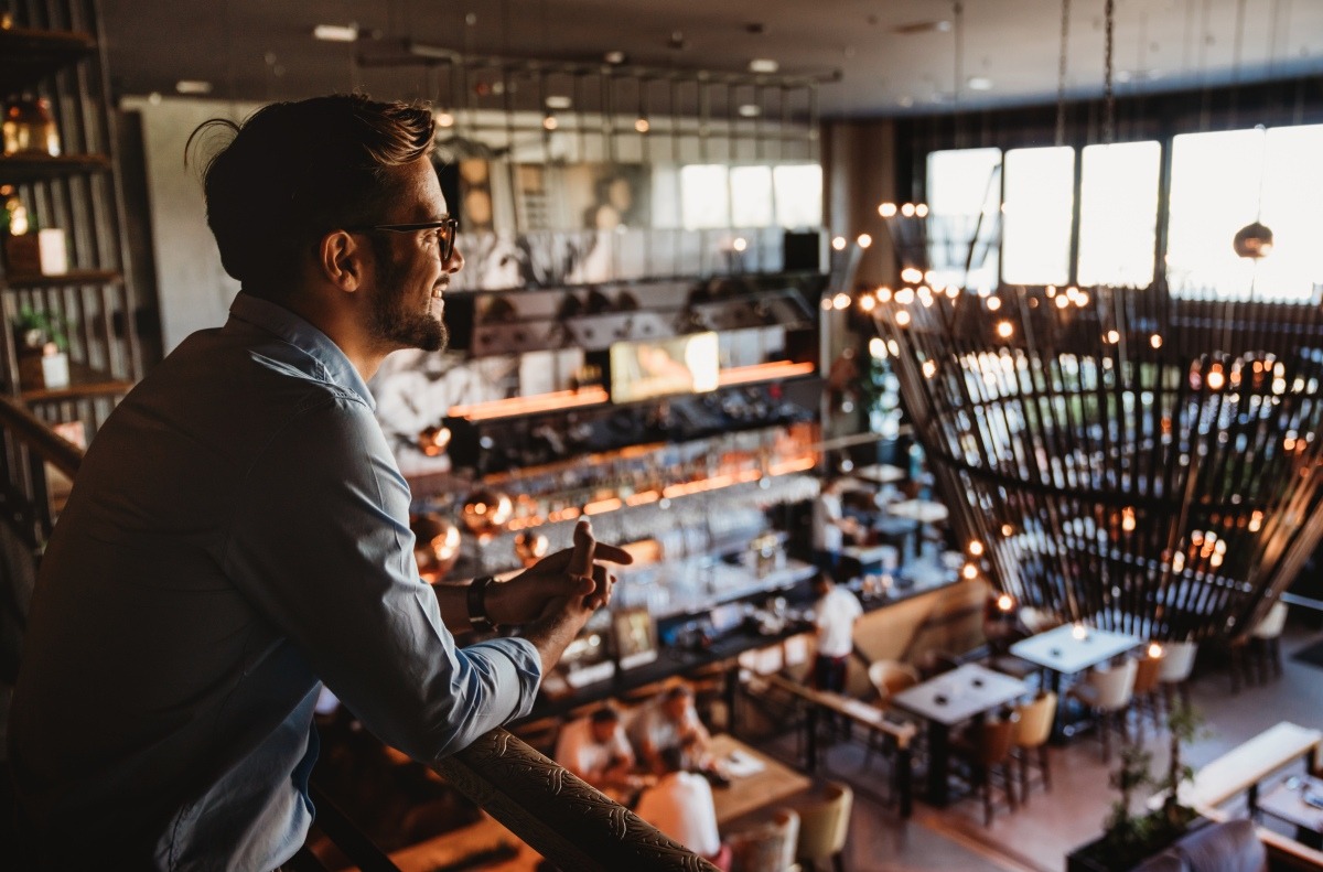 Restaurant owner overlooking his restaurant space