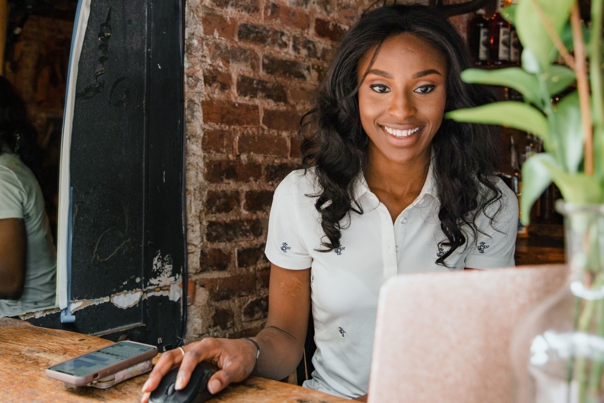 restaurant worker evaluating event management software options on a laptop