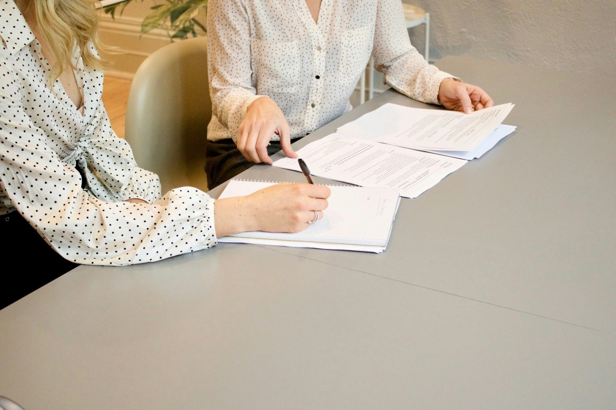 women discussing venue contract