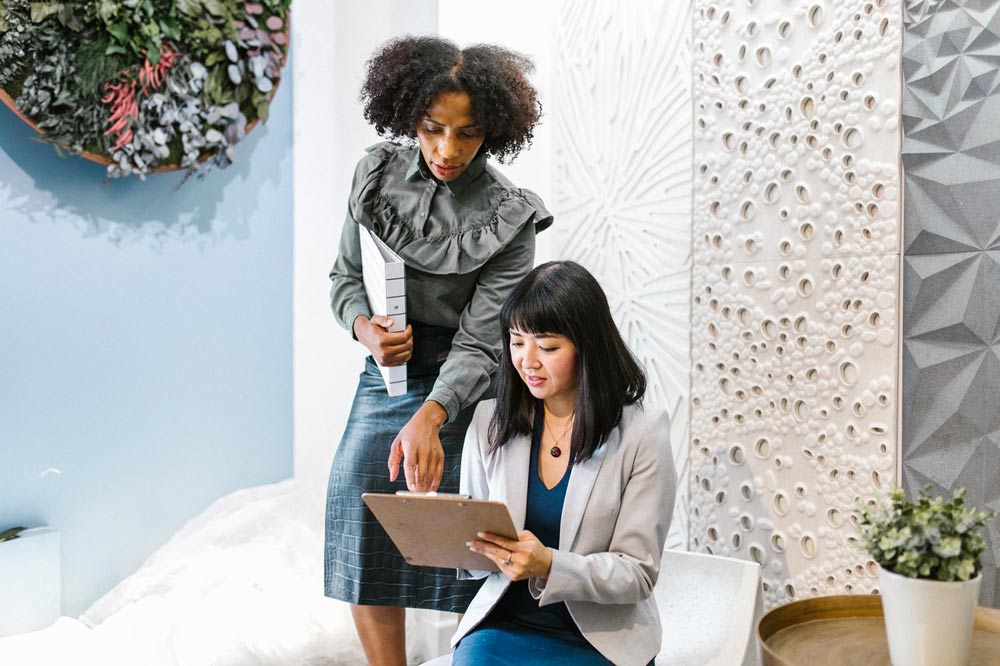 Women reviewing Planning Pod features