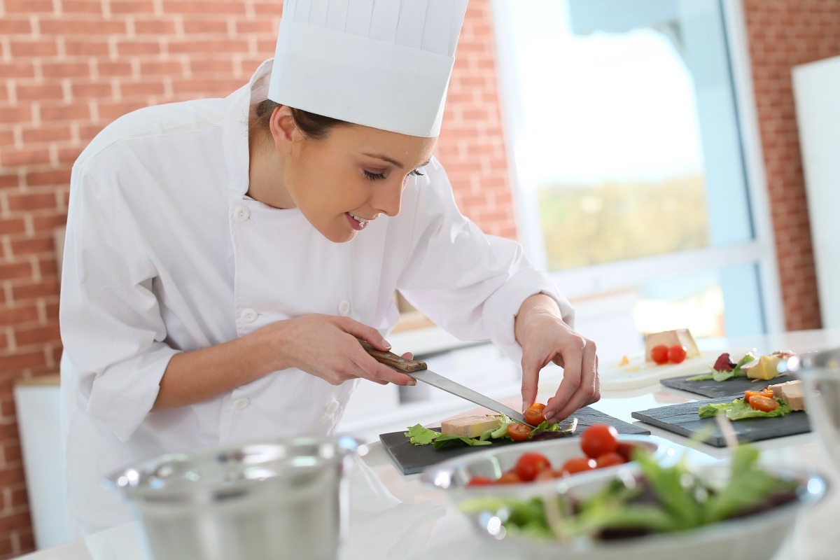 Caterer working on plated food