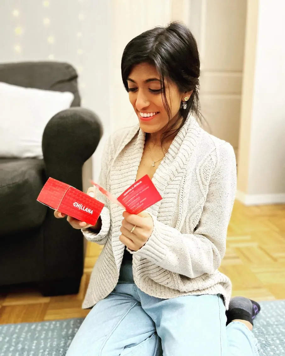 a woman holding a red box
