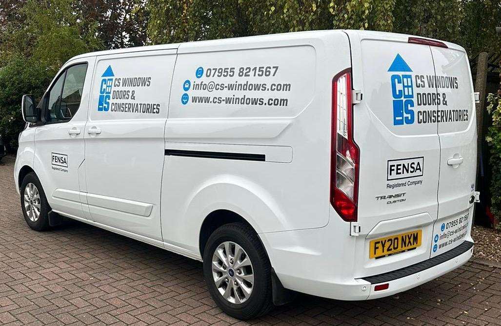 A white van with CS windows, doors and conservatories advertisement on.