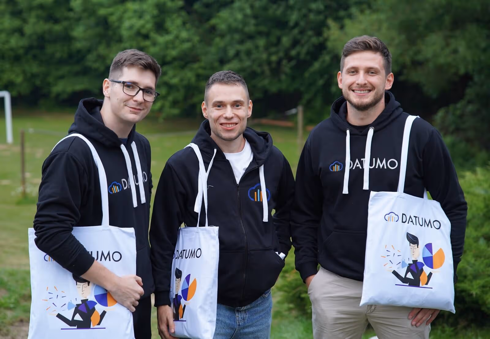 A group photo of Datumo employees in new branded merchandise.