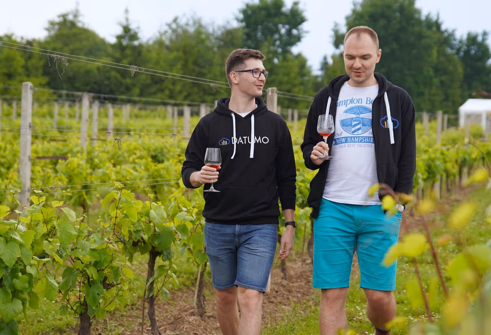 Two Datumo developers walking through vineyard