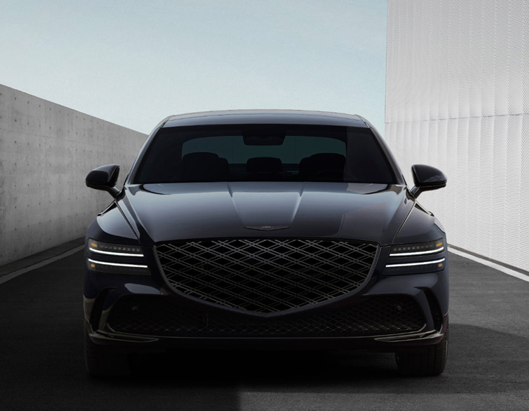 Couple driving Genesis vehicle