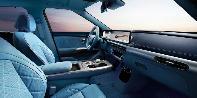 Woman holding smartphone in GV60