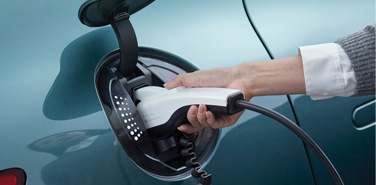 Man charging his GV60 on city street