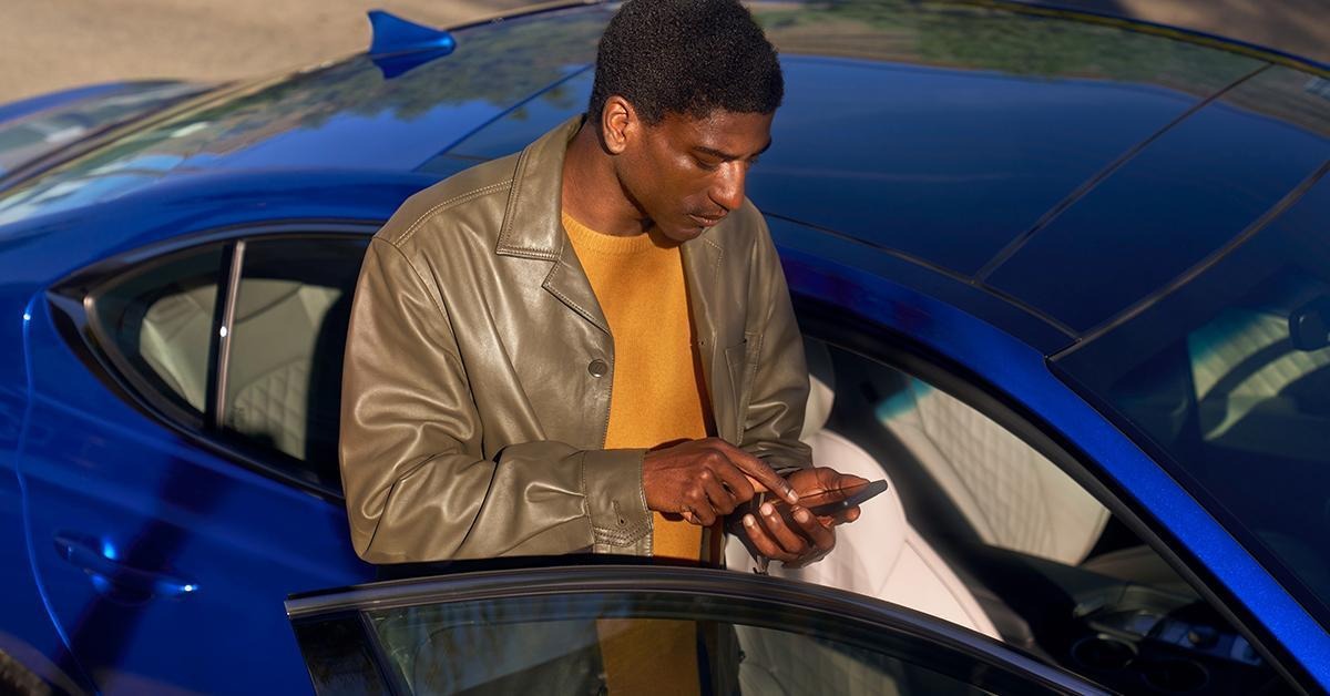 Man using phone gets into Genesis G70