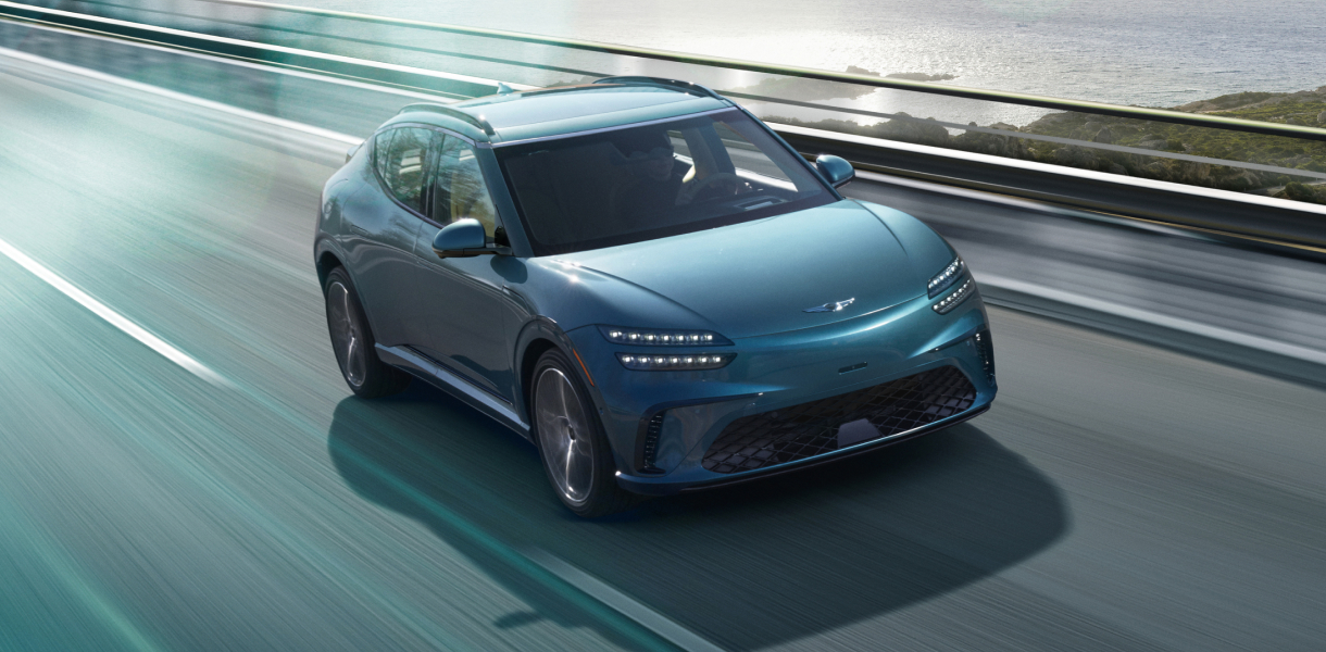 Front 3/4 view of GV60 driving on dirt terrain