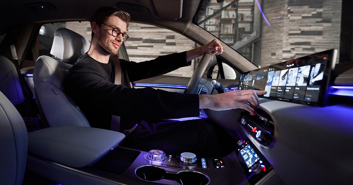 Man reaches for Genesis GV70’s 27-inch OLED Instrument Cluster and Navigation System display