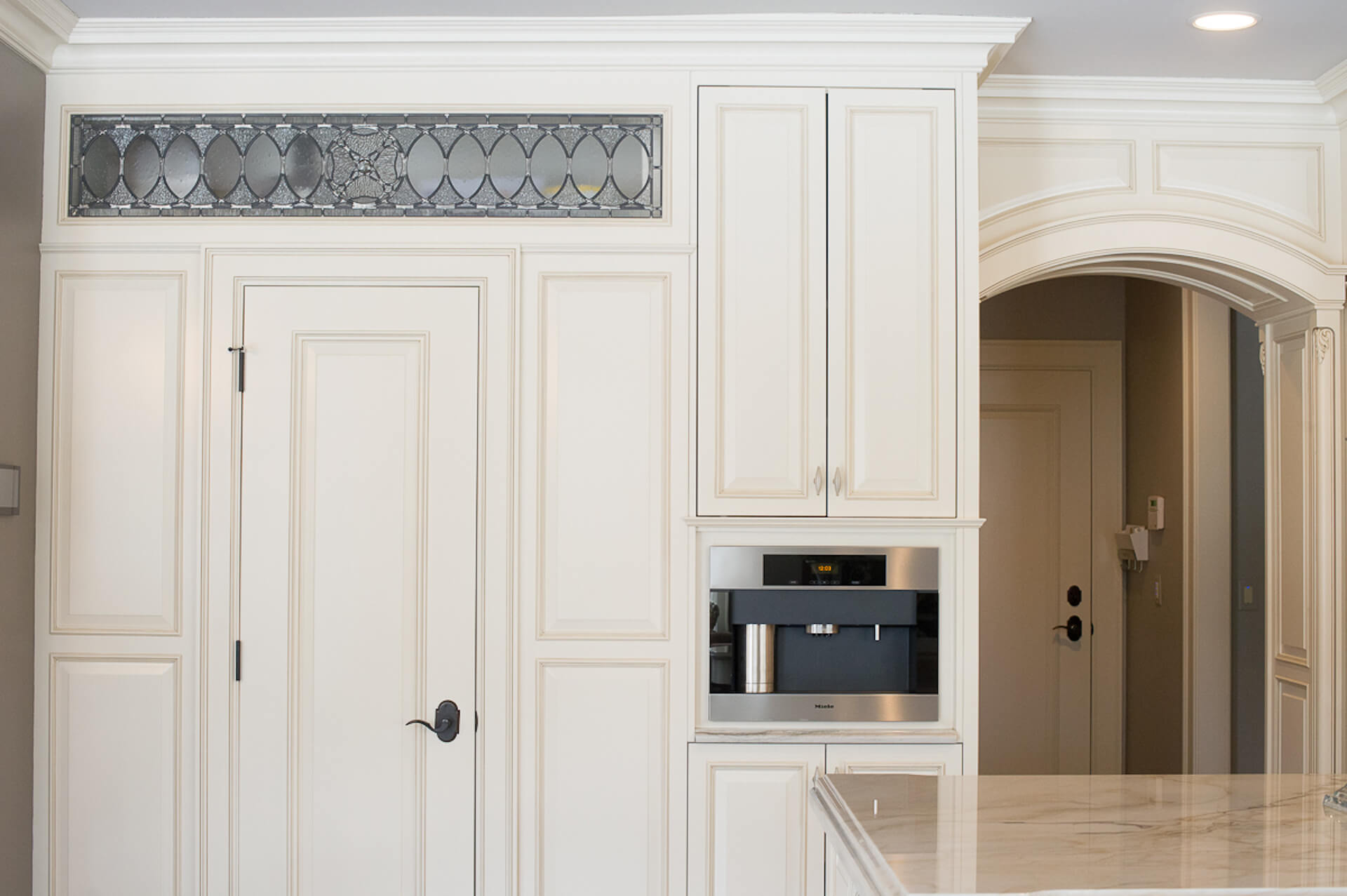 White paneled pantry and built in coffee maker