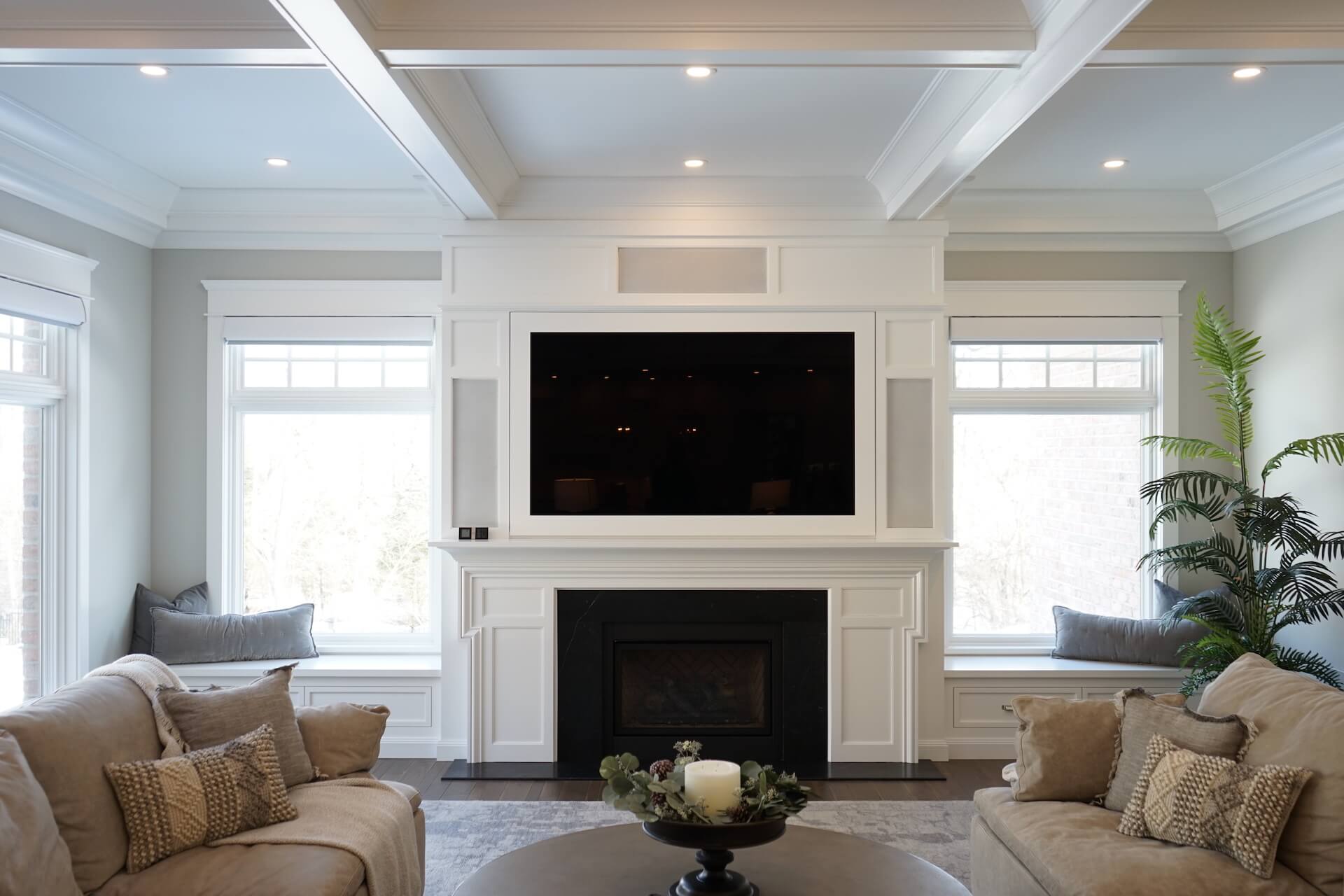 White family room with tv over fireplace