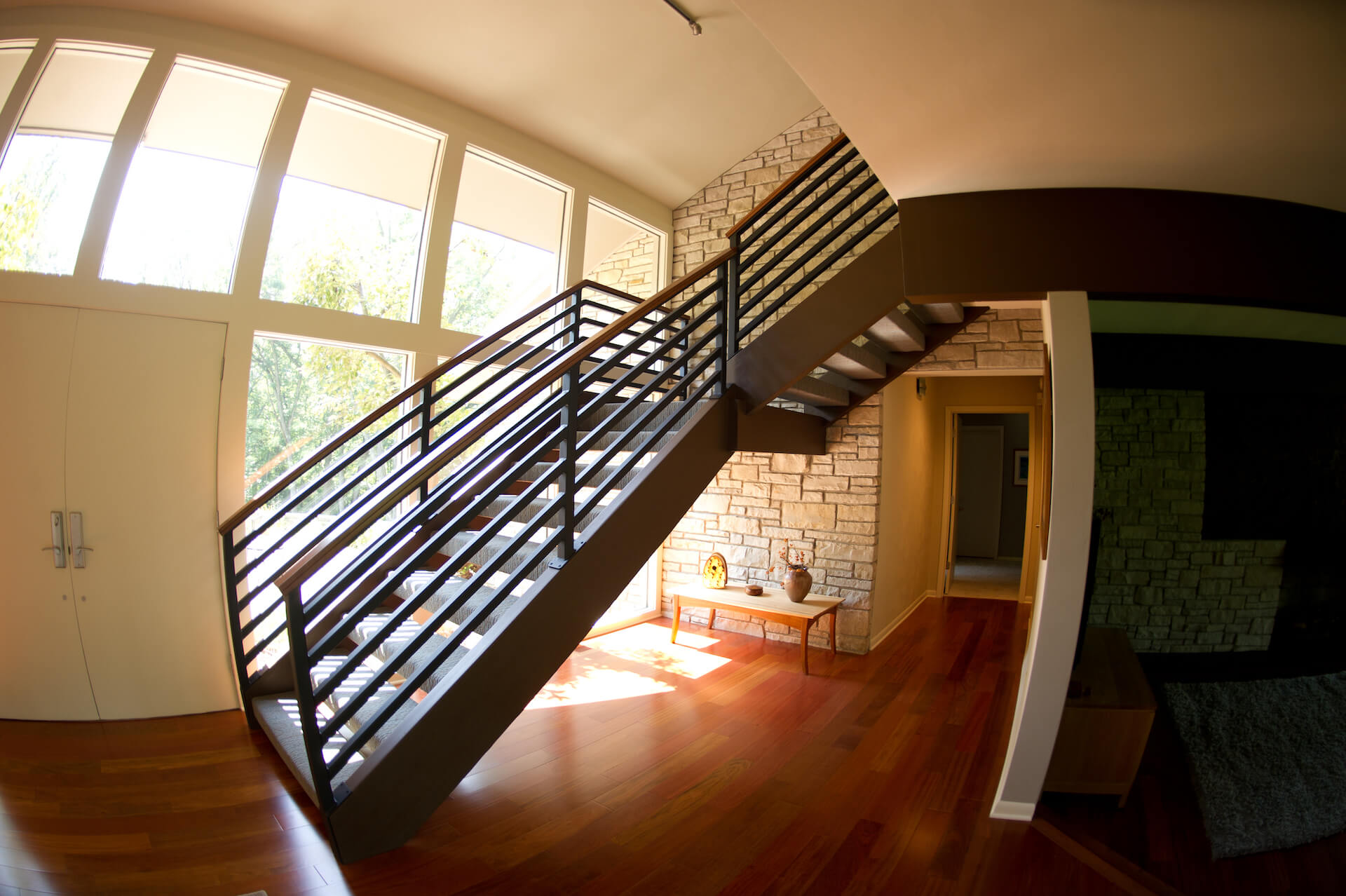 Metal wrapping staircase in MCM home