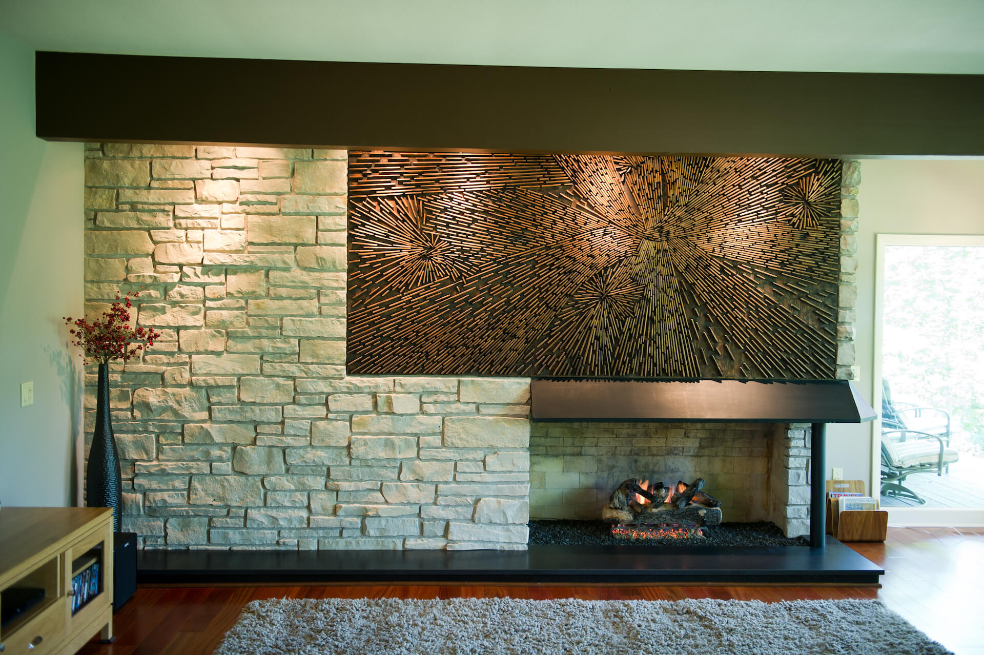 MCM stone fireplace and brass artwork