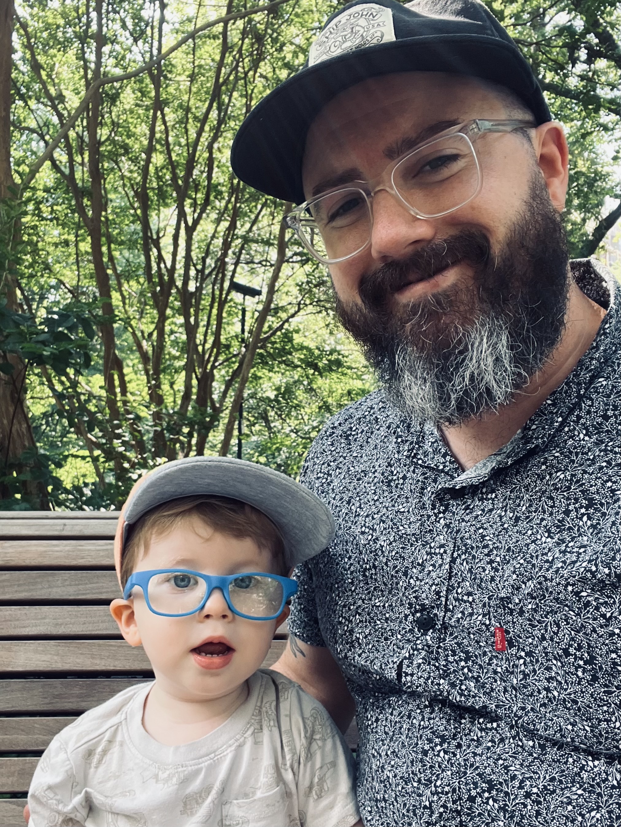 Image of website's author and child on park bench
