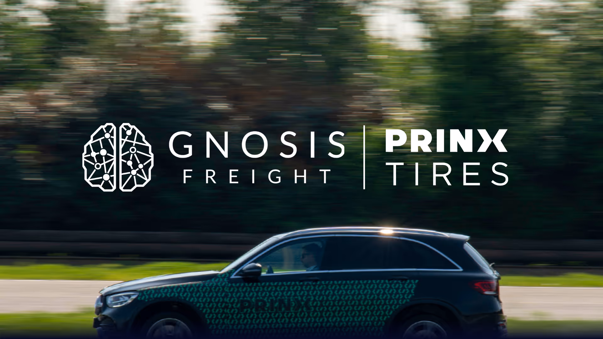 Black SUV driving on a road with Gnosis Freight and Prinx Tires logos above it.