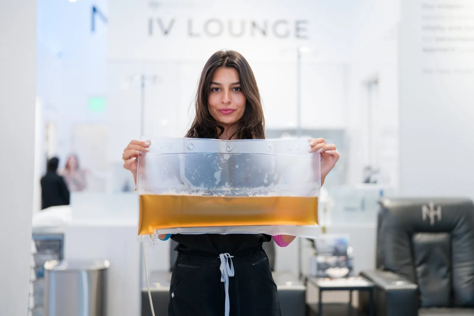 A Next Health clinician holding a bag of plasma removed during a TPE session